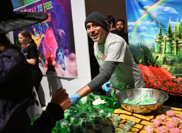 Dustin Schoof serves ice cream at the WFMZ booth Saturday, Jan. 4, 2025, during Ice Cream Wars at Da Vinci Science Center in Allentown. The annual event features Lehigh Valley businesses creating unique flavors of ice cream, with attendees casting votes to determine the champion. (Amy Shortell/The Morning Call)