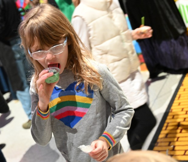 Skylar Mandic, 8, samples ice cream from the WFMZ booth Saturday, Jan. 4, 2025, during Ice Cream Wars at Da Vinci Science Center in Allentown. The annual event features Lehigh Valley businesses creating unique flavors of ice cream, with attendees casting votes to determine the champion. (Amy Shortell/The Morning Call)