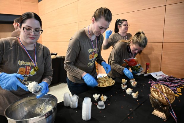 Team Victualic's Paige Pearsall, left, Shauna Carty and Maddie McConnell build their ice cream dish Saturday, Jan. 4, 2025, during Ice Cream Wars at Da Vinci Science Center in Allentown. The annual event features Lehigh Valley businesses creating unique flavors of ice cream, with attendees casting votes to determine the champion. (Amy Shortell/The Morning Call)