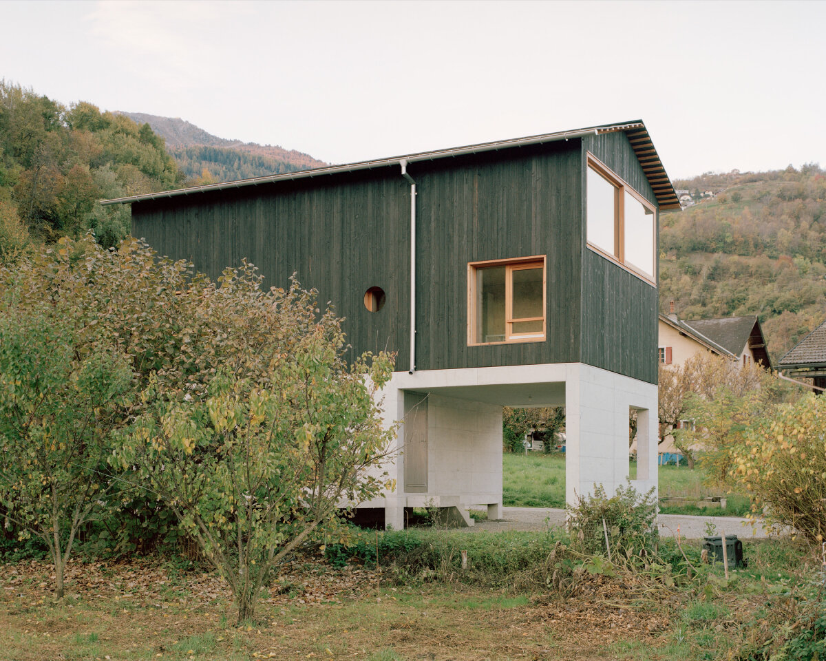 lionel ballmer architectes' charred wood house echoes traditional barns of rural switzerland