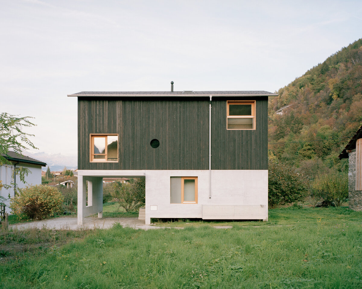 lionel ballmer architectes' charred wood house echoes traditional barns of rural switzerland