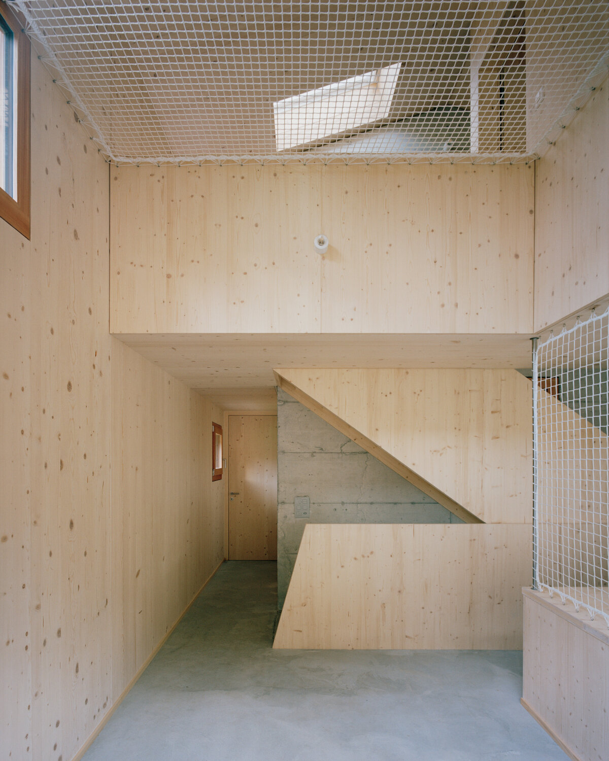 lionel ballmer architectes' charred wood house echoes traditional barns of rural switzerland