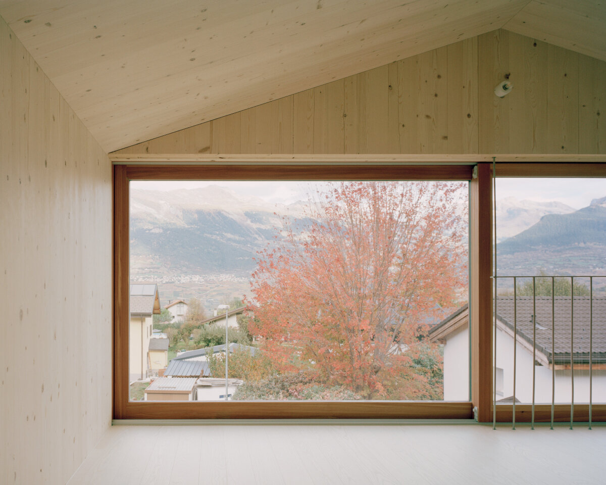 lionel ballmer architectes' charred wood house echoes traditional barns of rural switzerland