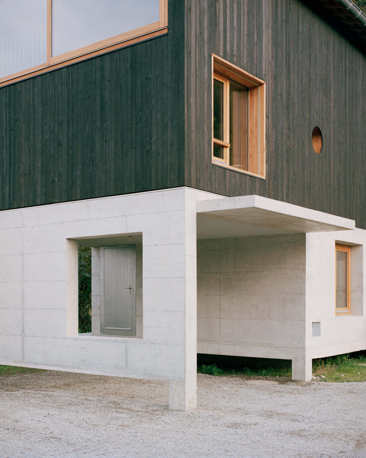 lionel ballmer architectes' charred wood house echoes traditional barns of rural switzerland