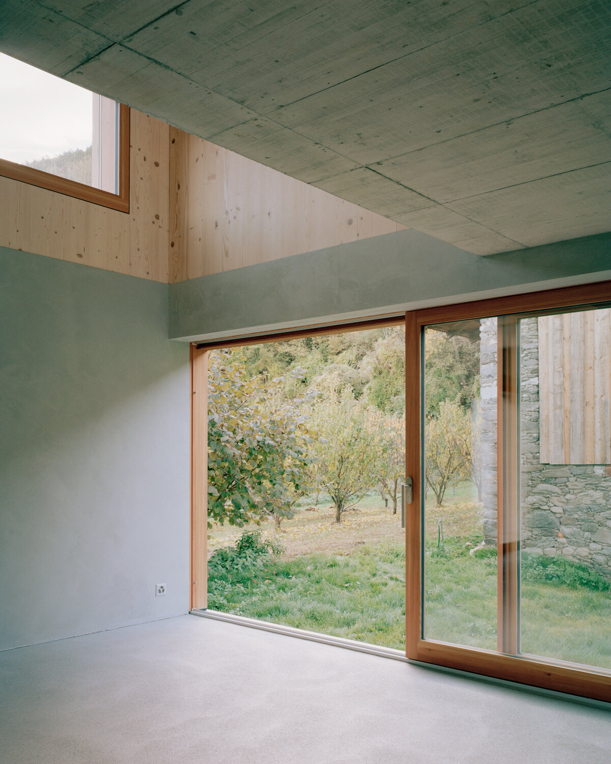lionel ballmer architectes' charred wood house echoes traditional barns of rural switzerland