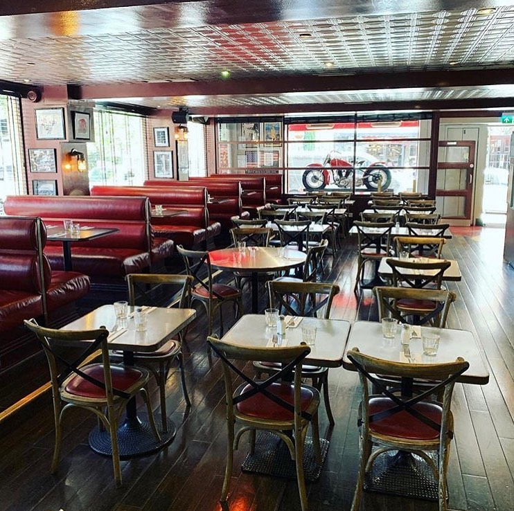 Interior view of Sticky Fingers restaurant with booths and tables.