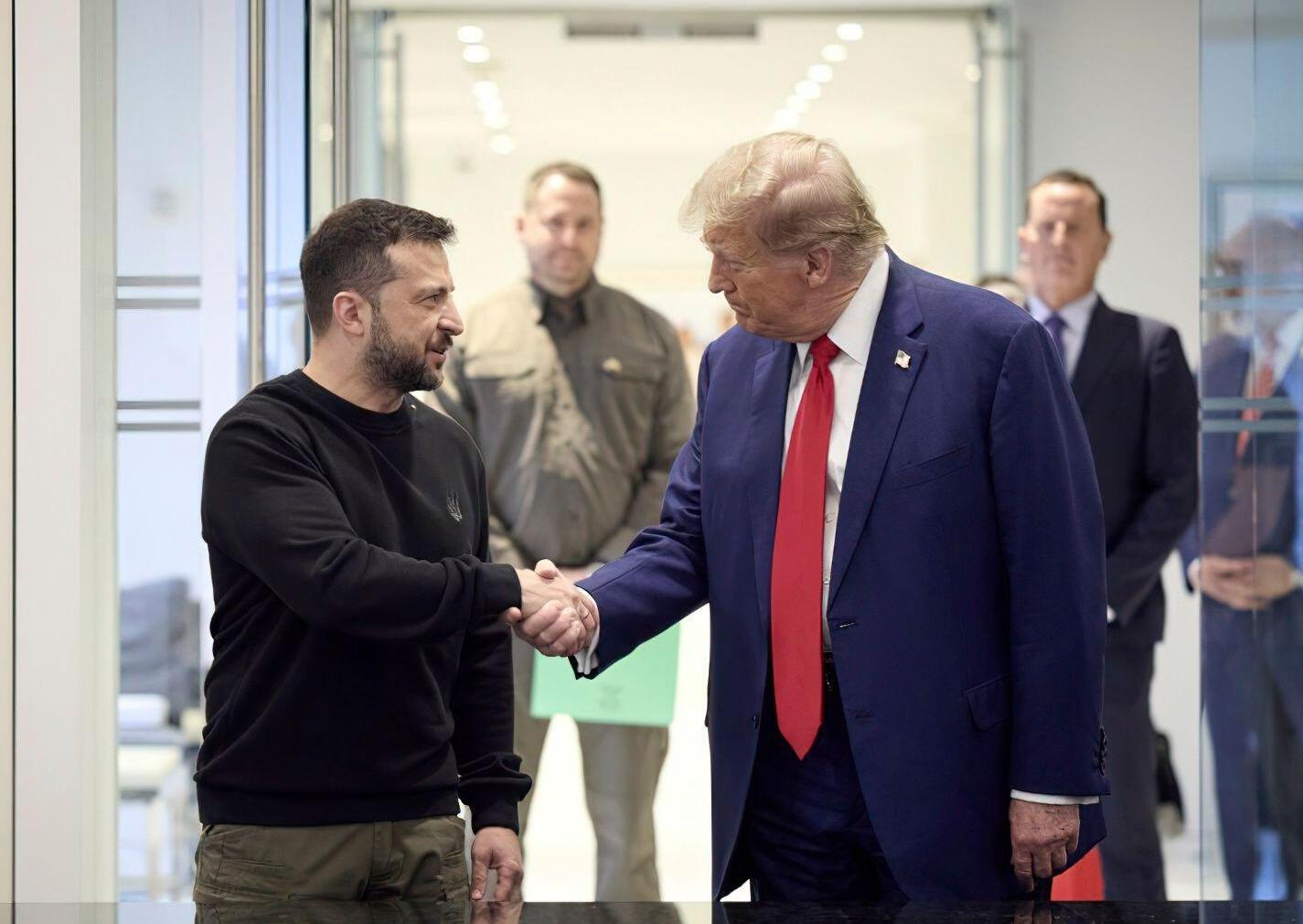 Volodymyr Zelensky and Donald Trump shaking hands.