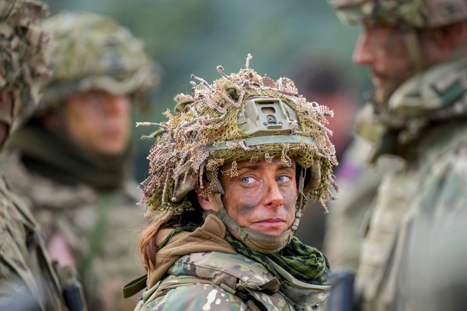 A female soldier in camouflage gear.