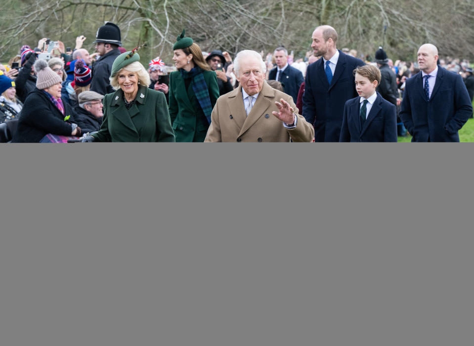 King Charles and Queen Camilla walking to church on Christmas wearing long coats with Prince William, Princess Kate and Prince George walking behind them and a crowd of fans