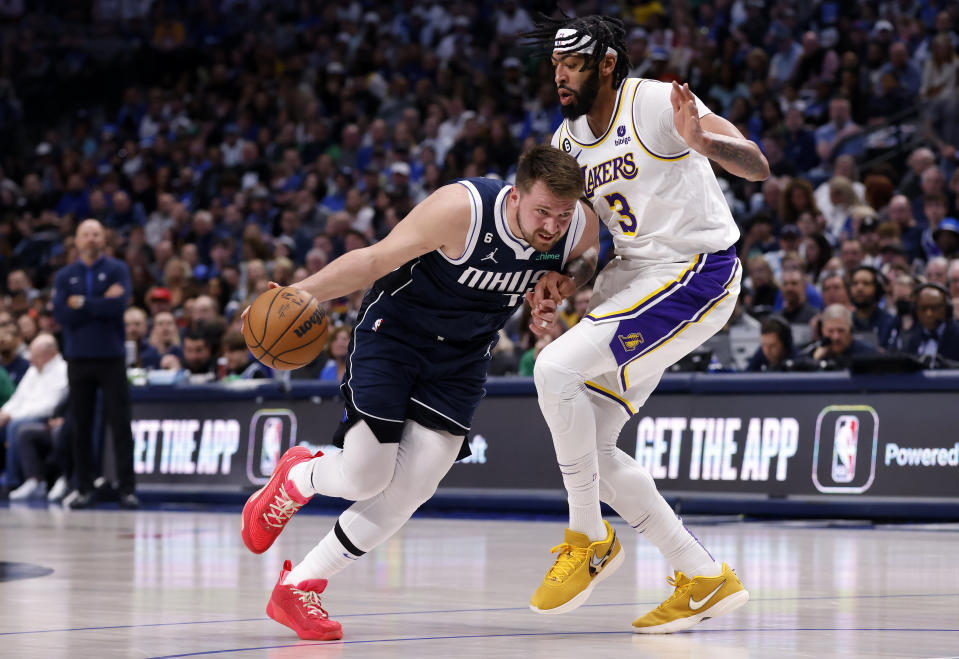DALLAS, TX - FEBRUARY 26: Luka Doncic #77 of the Dallas Mavericks handles the ball against Anthony Davis #3 of the Los Angeles Lakers in the first half of the game at American Airlines Center on February 26, 2023 in Dallas, Texas. NOTE TO USER: User expressly acknowledges and agrees that, by downloading and or using this photograph, User is consenting to the terms and conditions of the Getty Images License Agreement. (Photo by Ron Jenkins/Getty Images)