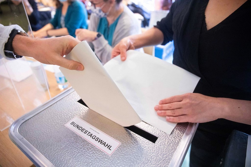 A voter casts a ballot for federal elections at a polling station in Berlin A voter casts a ballot for federal elections at a polling station in Berlin