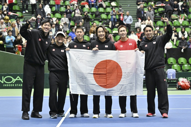 Japan celebrate their qualifying win over Britain in Miki (STR)