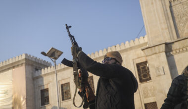 An opposition fighter fires his AK-47