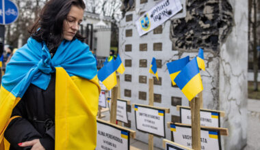 Woman in Ukrainian flag Warsaw