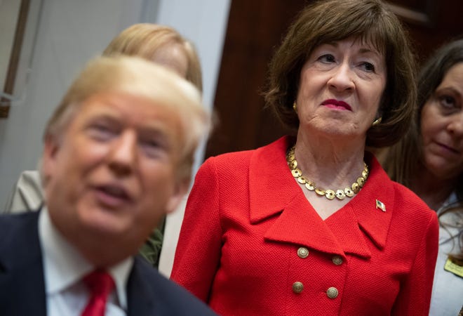 US Senator Susan Collins, Republican of Maine, stands alongside US President Donald Trump as he signs bills intended to lower prescription drug prices during a ceremony in the Roosevelt Room of the White House in Washington, DC, October 10, 2018.
