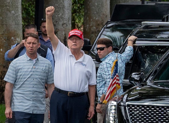 President Donald Trump waves to supporters in West Palm Beach, Fla., on Feb. 17, 2025.