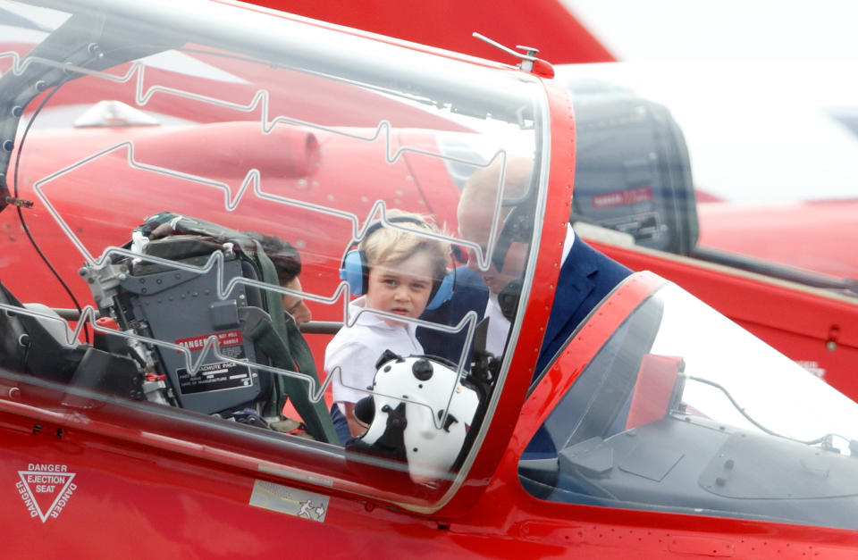 Prince William, Duke of Cambridge and Prince George of Cambridge view a Red Arrow Hawk T1A aircraft as they visit the Royal International Air Tattoo at RAF Fairford on July 8, 2016 in Fairford, England