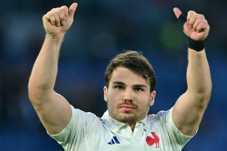 Twice as good: France scrum-half Antoine Dupont, who scored two tries, celebrates victory in Italy (Andreas SOLARO)