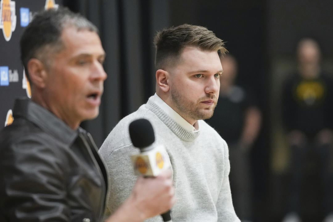 Lakers general manger Rob Pelinka and Luka Dončić field questions at Dončić's introductory news conference. (AP Photo/Jae C. Hong)