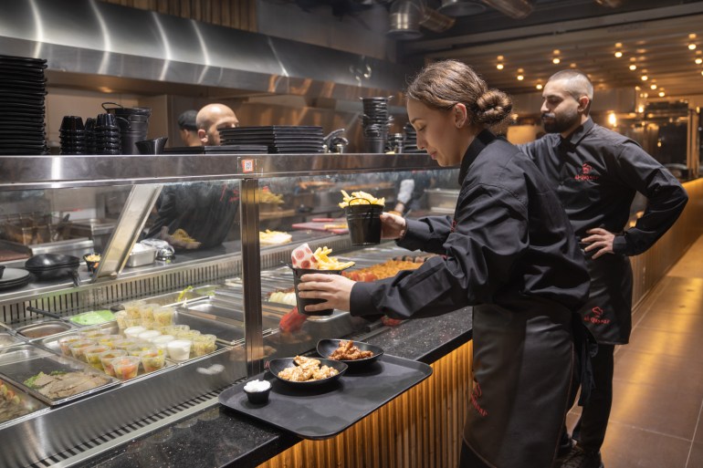 Waiters picking up their orders at an open pass