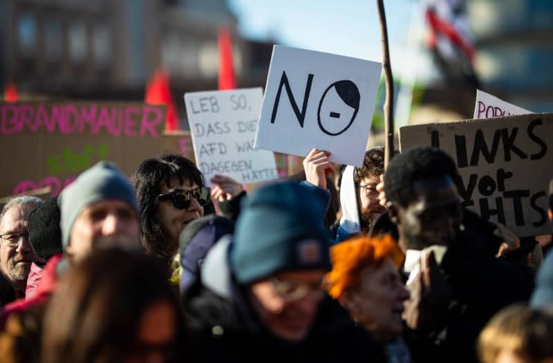 People take part in a demonstration against a tougher migration policy in Germany. Demonstrators took to the streets across Germany against efforts by the centre-right Christian Democratic Union (CDU) to push through reforms to migration laws in parliament with the support of the far-right Alternative for Germany (AfD). Christoph Schmidt/dpa