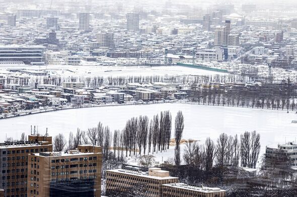 Snowy Winter Street Scene With Modern Buildings in Sapporo City