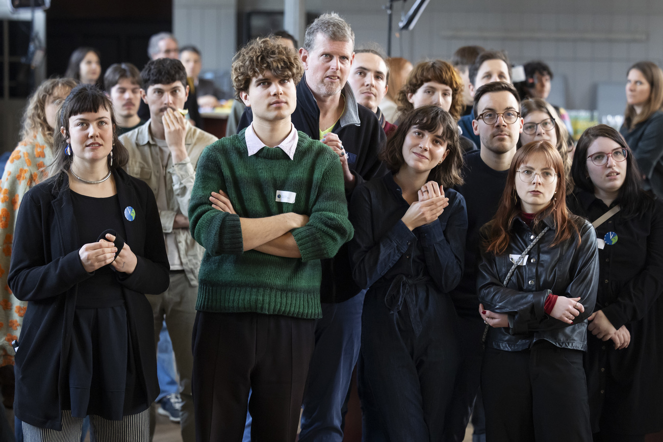 In the front row from left to right: Olivia Senn, Young Greens campaigner, Linus Dolder, Young Greens member Magdalena Erni, Co-President of the Young Greens, Mirjam Hostetmann, President of JUSO, react to the projected rejection of the only federal initiative on the ballot, the “environmental responsibility initiative”, on Sunday February 9, 2025.