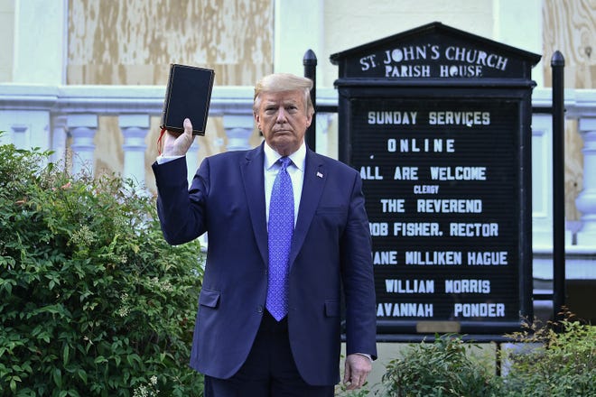 President Donald Trump holds up a Bible outside the St. John's Church across from the White House on June 1, 2020. Hundreds of peaceful protesters had gathered outside the White House that day, and there had been no reports of illegal conduct. About 6:30 p.m., law enforcement officers suddenly began using force to clear the area to make way for Trump’s walk to the church. They fired pepper spray and rubber bullets as they punched and pushed protesters, journalists and even priests.