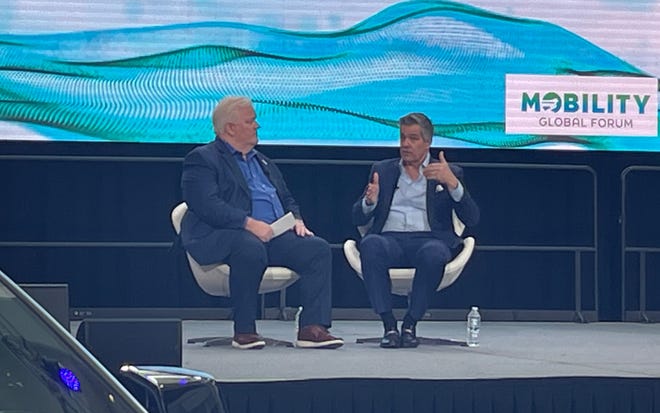 John Bozzella, president and CEO of the Alliance for Automotive Innovation, right, speaks with Glenn Stevens, executive director of MichAuto, during this year's Detroit Auto Show. The alliance has released a new study quantifying the impact of the auto industry.