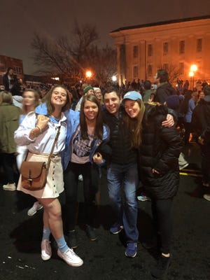 Capt. Rebecca Lobach and her friends celebrate a University of North Carolina basketball victory in Chapel Hill, North Carolina, on Feb. 20, 2019.