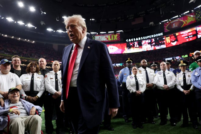 U.S. President Donald Trump reacts after posing with family members of victims in the January 1 attack on Bourbon Street prior to Super Bowl LIX between the Kansas City Chiefs and the Philadelphia Eagles at Caesars Superdome on February 09, 2025 in New Orleans, La.