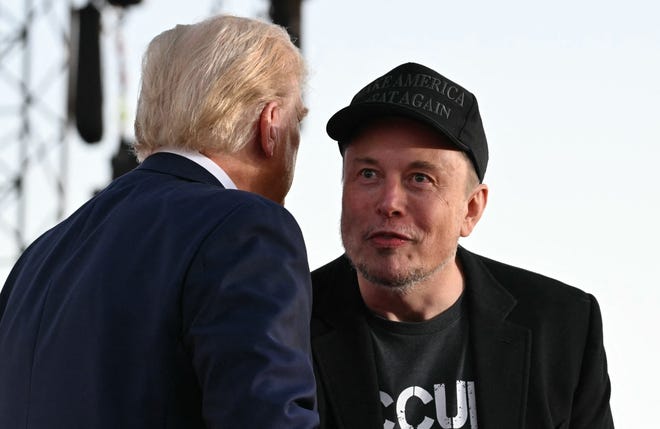 Tesla CEO Elon Musk (R) joins former US President and Republican presidential candidate Donald Trump during a campaign rally at site of his first assassination attempt in Butler, Pennsylvania on October 5, 2024.