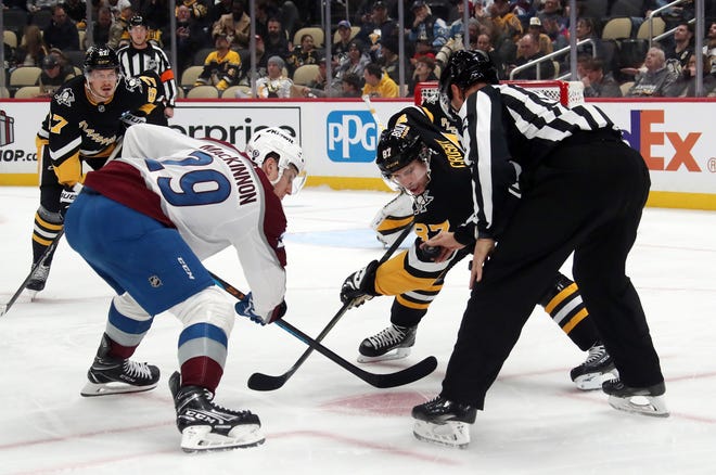 Dec 10, 2024; Pittsburgh, Pennsylvania, USA; Colorado Avalanche center Nathan MacKinnon (29) and Pittsburgh Penguins center Sidney Crosby (87) take a face-off during the second period at PPG Paints Arena. Mandatory Credit: Charles LeClaire-Imagn Images