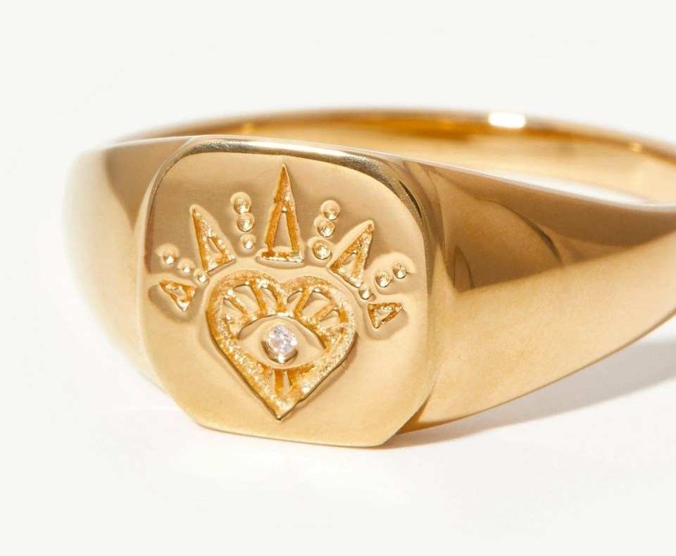 Gold signet ring with an eye design.