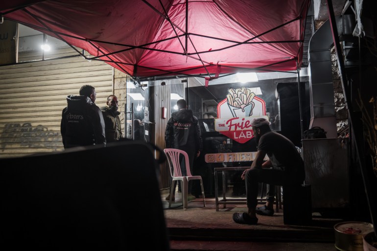 Delivery drivers waiting outside Fries Lab for orders in Dahiyeh, Beirut, on January 19, 2025