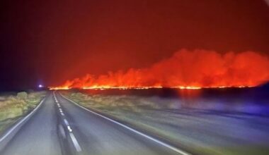 Horizon lit up in burning orange by huge grass fire in Wales
