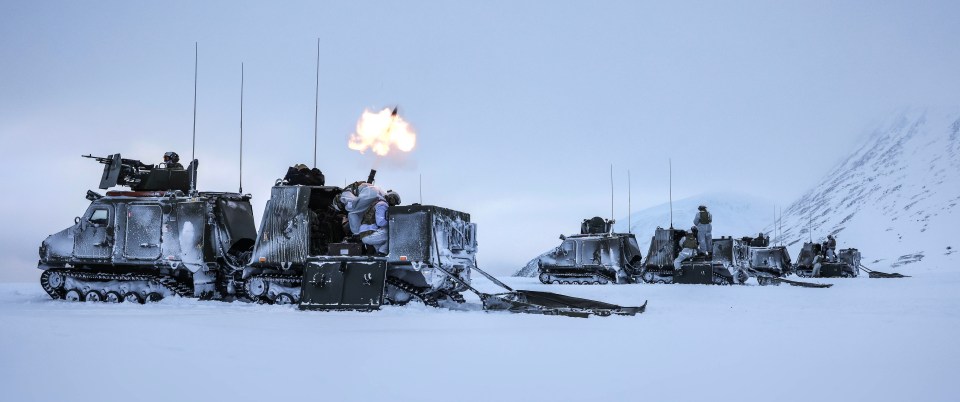Royal Marines firing mortars from Viking vehicles in Norway.