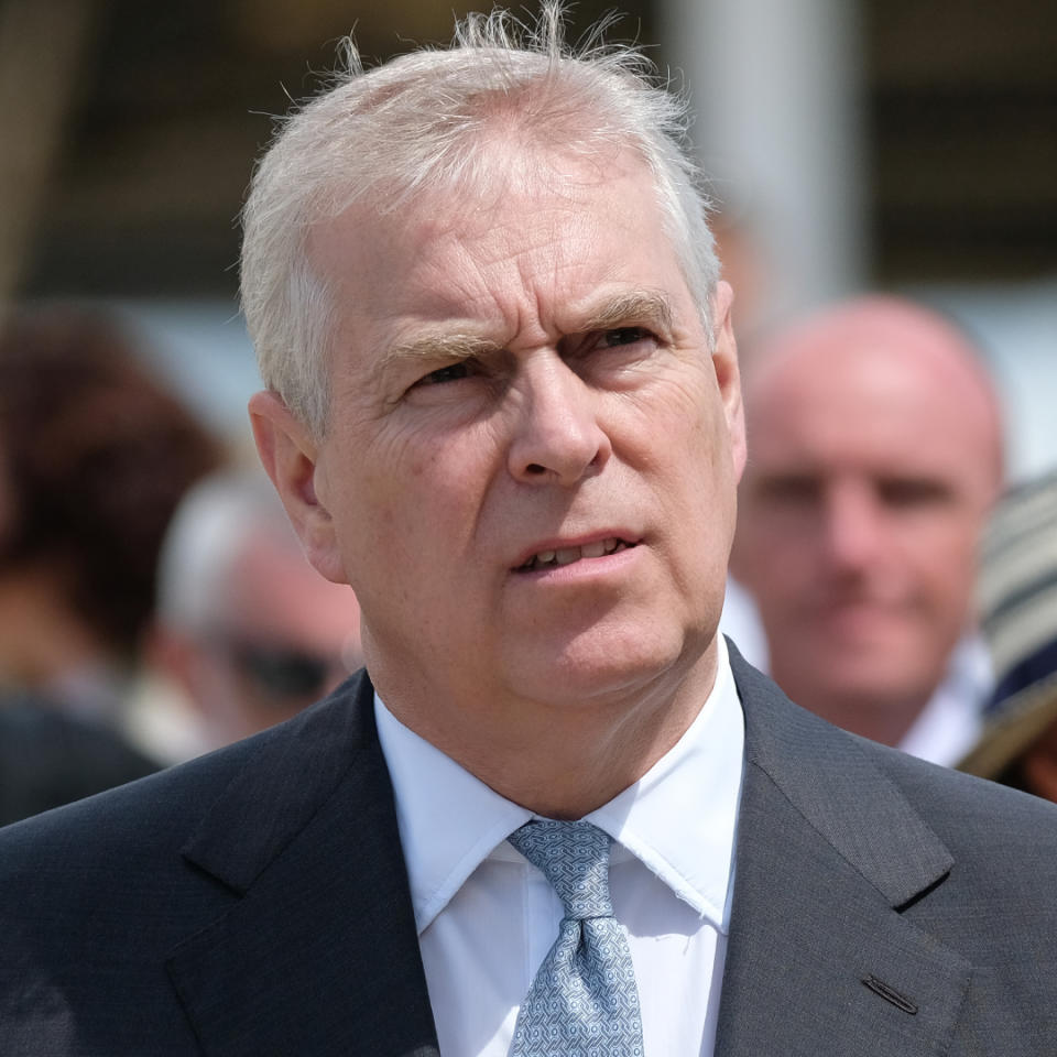 Prince Andrew has gray hair and looks pensive while wearing a suit.