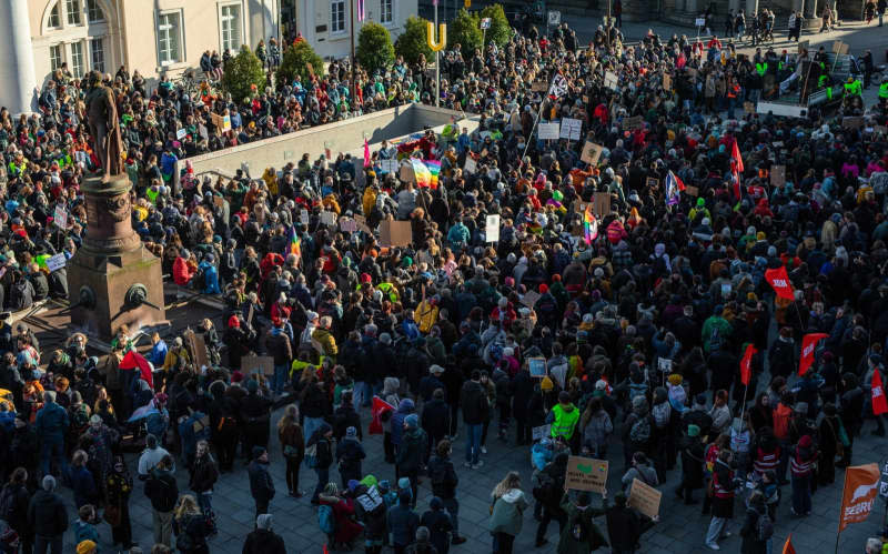 People take part in a demonstration against a tougher migration policy in Germany. Demonstrators took to the streets across Germany against efforts by the centre-right Christian Democratic Union (CDU) to push through reforms to migration laws in parliament with the support of the far-right Alternative for Germany (AfD). Christoph Schmidt/dpa