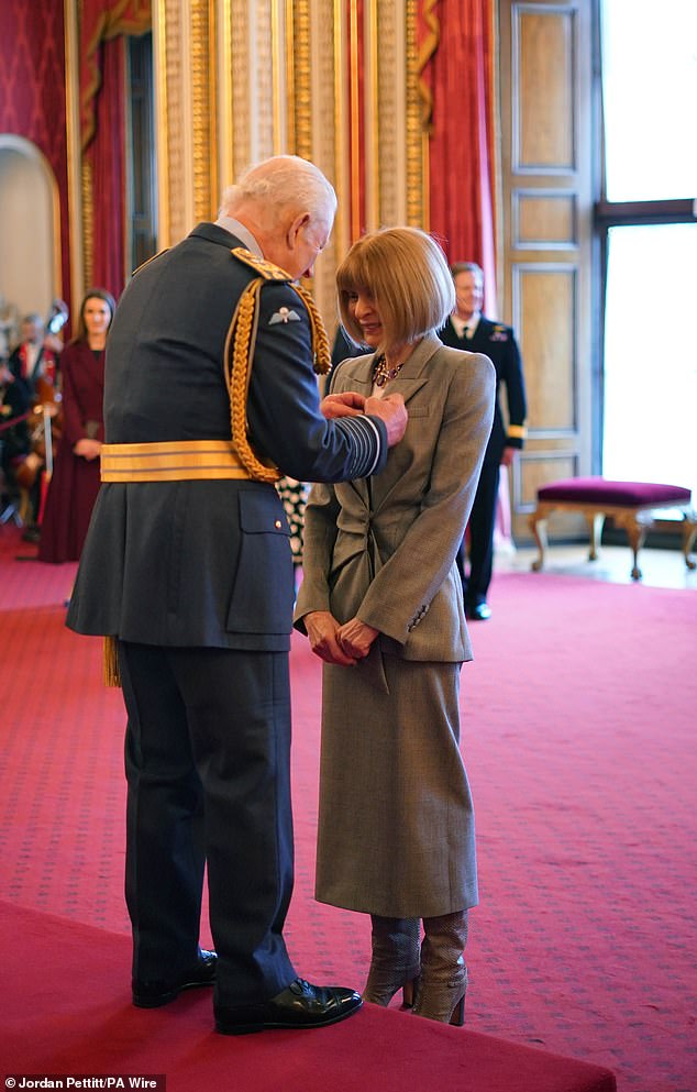 The steeliest woman in fashion broke character and allowed herself a big smile as she received her medal