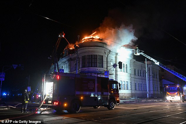 Ukrainian firefighters try to put out a fire in a building after a drone strike in Kharkiv on February 5, 2025