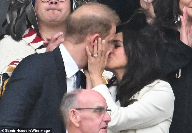 No photo op was missed by the pair at the Invictus Games, when Meghan cradled her husband's face for a kiss