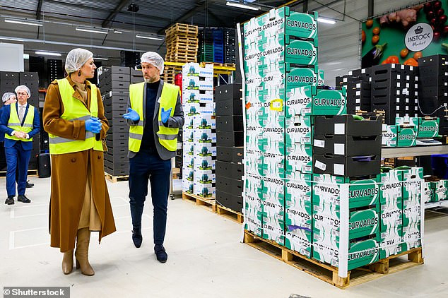 She was accompanied by a member of staff around the centre and donned a pair of bright blue rubber gloves, a white hair net and green hi-vis jacket