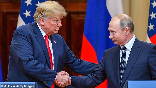 Donald Trump and Vladimir Putin shake hands before attending a joint press conference after a meeting at the Presidential Palace in Helsinki, in 2018