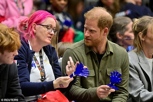 Harry speaks with a member of the crowd as he attends a sitting volleyball semi-final match between Britain and Nigeria