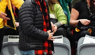 The PM draped himself in a scarf from New Zealand supporters while waiting for Harry to arrive, happily accepting every photo request