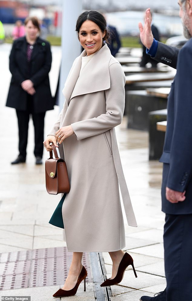 Meghan looked effortlessly elegant in the Mackage 'Mai' belted coat during a visit to Belfast in March 2018