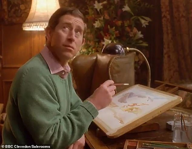 Pictured: King Charles working on a painting of Balmoral, which sold at auction for over £20,000 in March 2024