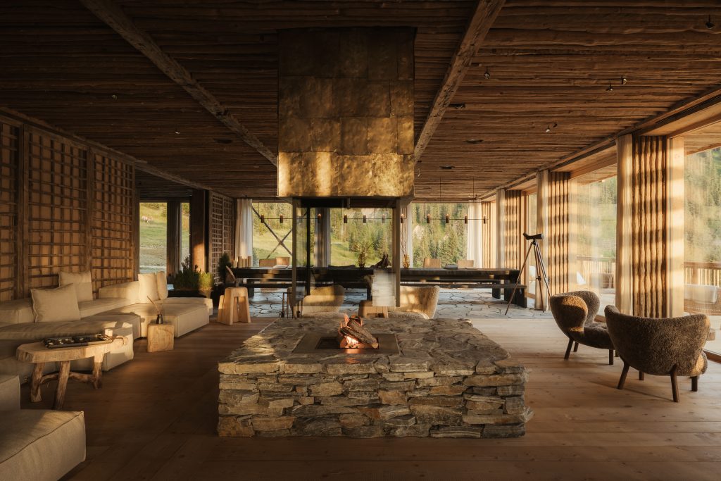 living room with fireplace in the center and windows all around