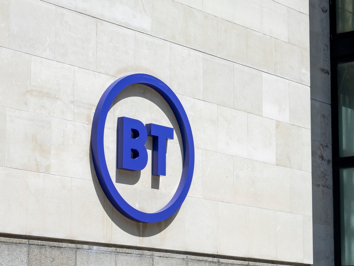A purple BT logo on the side of a bright office building.